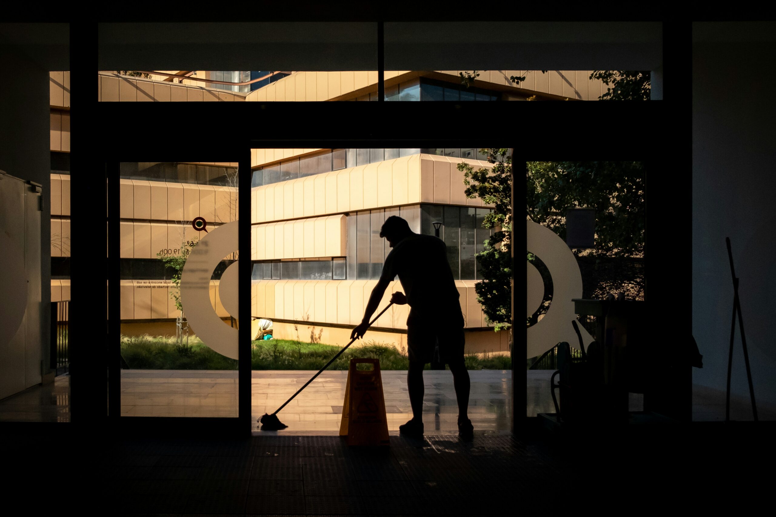 Professional carpet cleaner using equipment to deep clean a living room carpet, extending its lifespan.